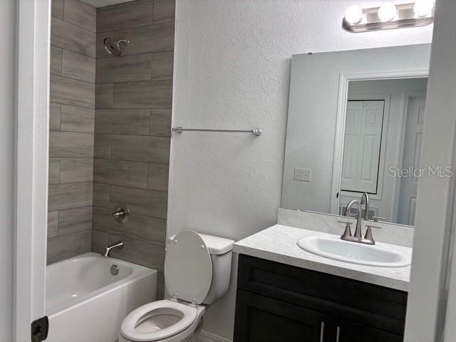 full bathroom with vanity, toilet, and tiled shower / bath