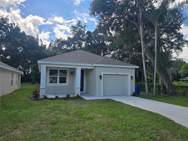 ranch-style home with a garage and a front lawn