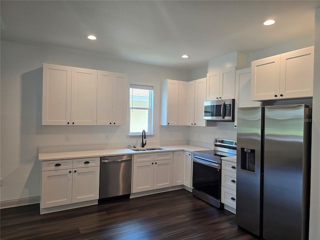 kitchen featuring white cabinets, stainless steel appliances, dark wood-type flooring, and sink