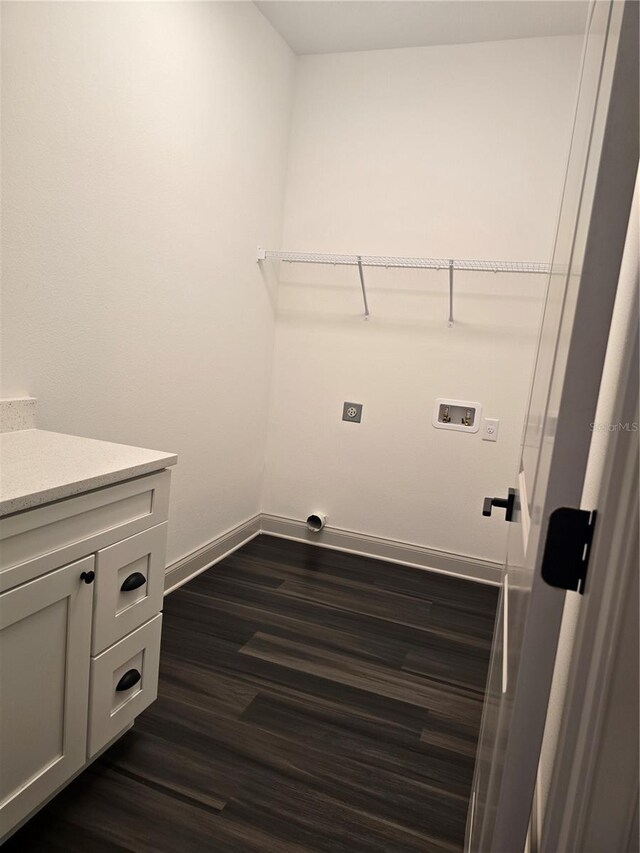 laundry area featuring electric dryer hookup, dark hardwood / wood-style floors, and hookup for a washing machine