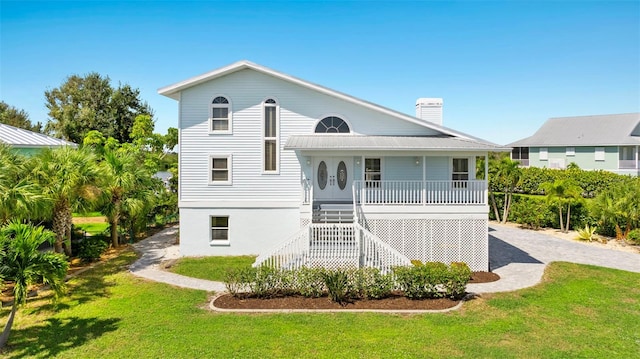 rear view of house featuring a lawn