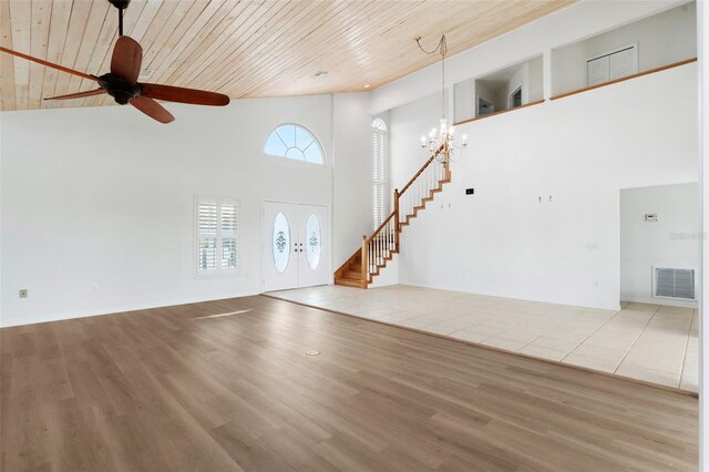 unfurnished living room with wooden ceiling, hardwood / wood-style flooring, ceiling fan with notable chandelier, and high vaulted ceiling