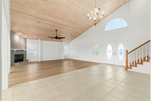 foyer with high vaulted ceiling, ceiling fan with notable chandelier, a fireplace, light wood-type flooring, and wooden ceiling