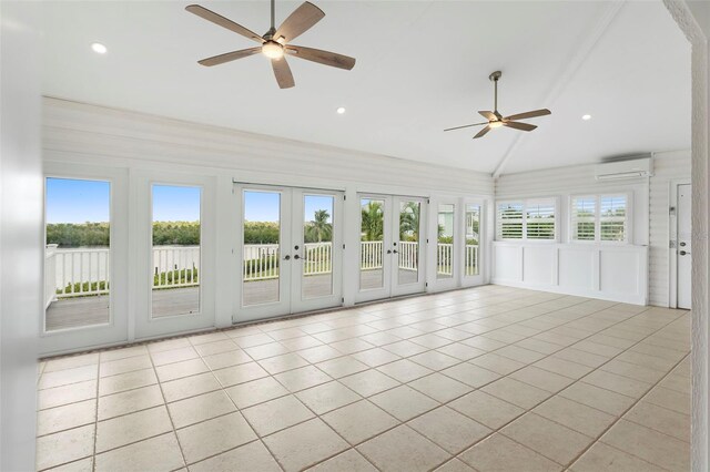 unfurnished sunroom with lofted ceiling, ceiling fan, a wall unit AC, and french doors