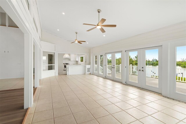 interior space with a wealth of natural light, ceiling fan, french doors, and high vaulted ceiling