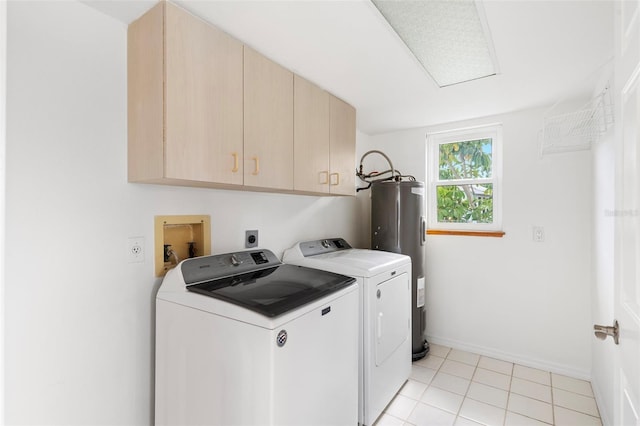 clothes washing area with cabinets, water heater, independent washer and dryer, and light tile patterned flooring