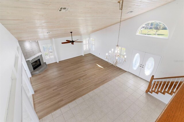 foyer entrance featuring light hardwood / wood-style flooring, ceiling fan with notable chandelier, high vaulted ceiling, and wooden ceiling