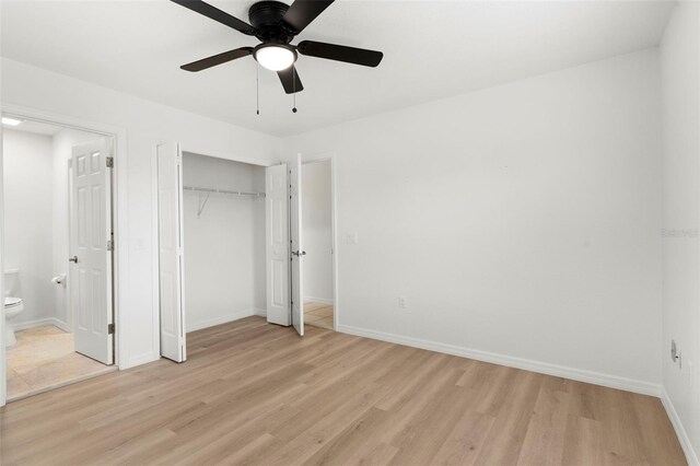 unfurnished bedroom featuring light hardwood / wood-style flooring, ensuite bath, and ceiling fan