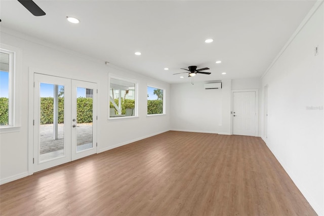 unfurnished living room with light hardwood / wood-style flooring, a wealth of natural light, and ceiling fan