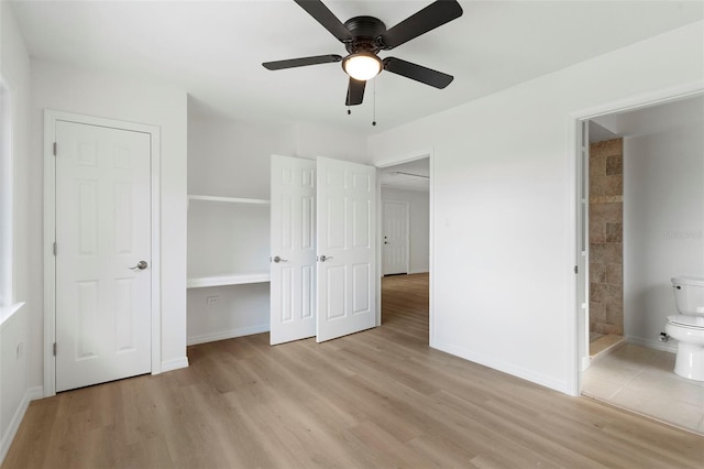 unfurnished bedroom featuring connected bathroom, light hardwood / wood-style floors, and ceiling fan