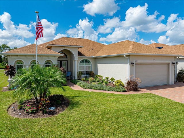 view of front of house with a garage and a front yard