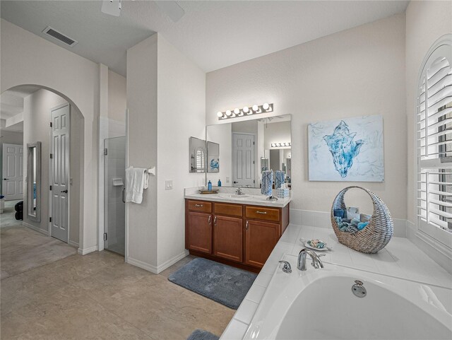 bathroom featuring independent shower and bath and vanity