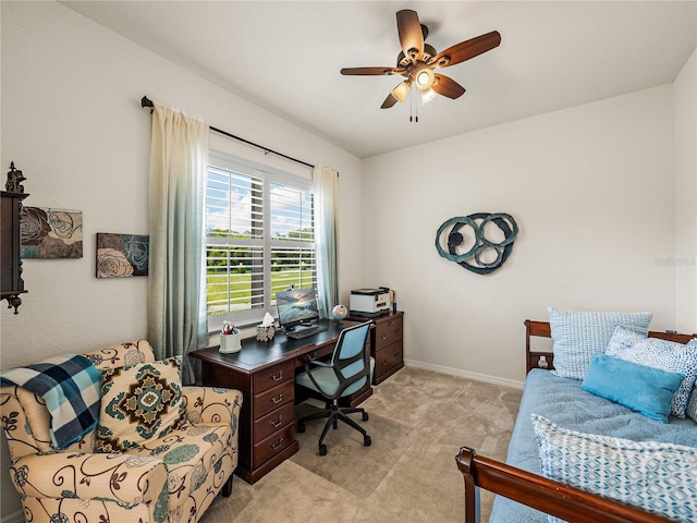 carpeted home office featuring ceiling fan