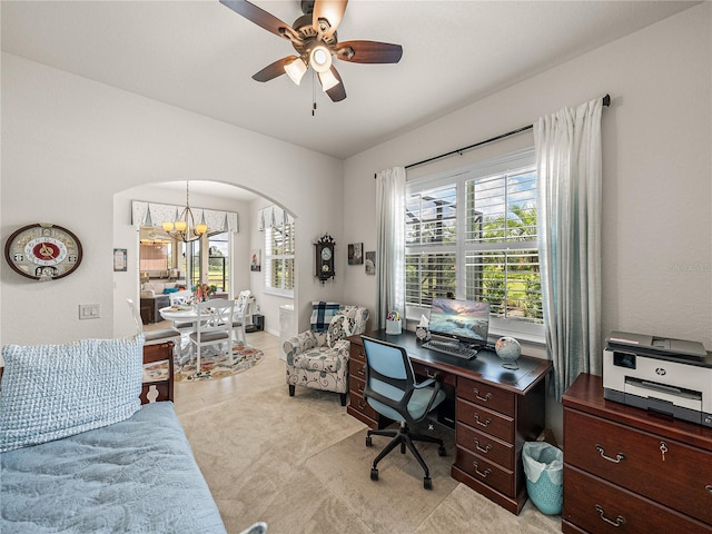 office space with light carpet and ceiling fan with notable chandelier