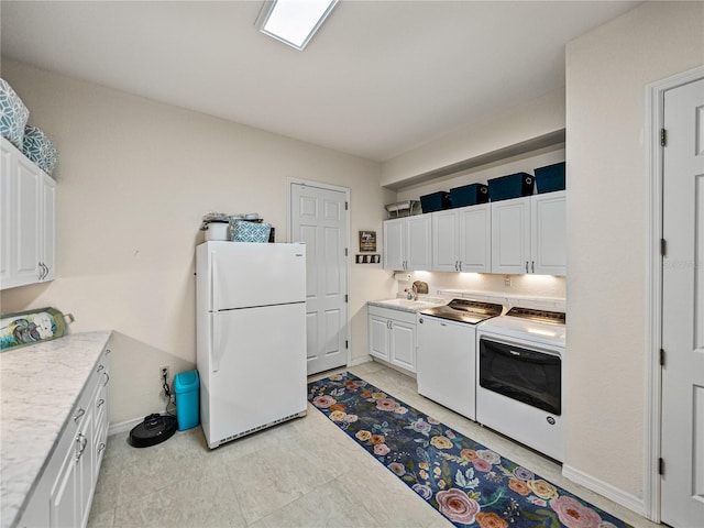 kitchen with white refrigerator, sink, white cabinetry, and washer / dryer