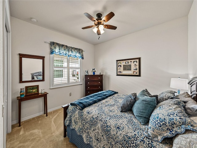 carpeted bedroom with ceiling fan and a closet