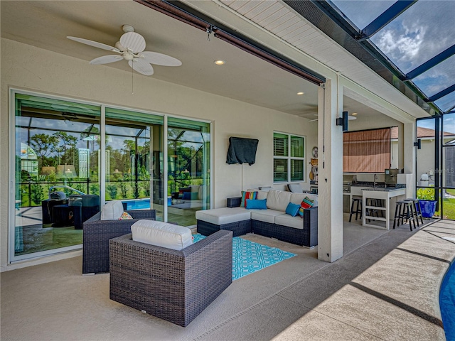 view of patio / terrace with an outdoor hangout area, glass enclosure, and ceiling fan