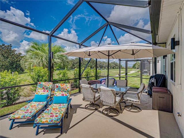 view of patio featuring glass enclosure and grilling area