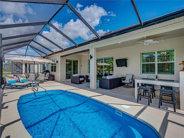 view of swimming pool with ceiling fan, an outdoor hangout area, a lanai, and a patio area