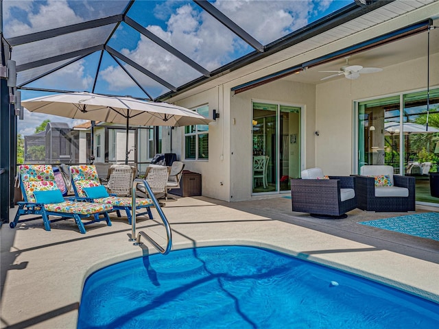 view of pool with a patio, outdoor lounge area, a lanai, and ceiling fan