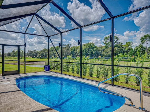 view of pool featuring a water view, a lanai, and a patio area