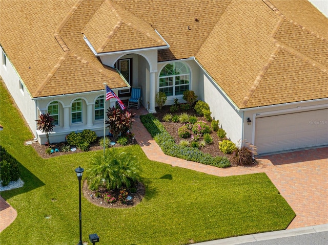 view of front of home with a garage and a front lawn