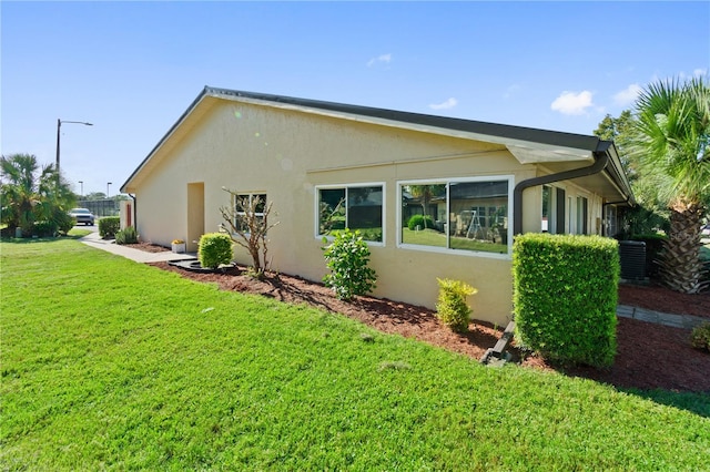 view of side of home with a yard