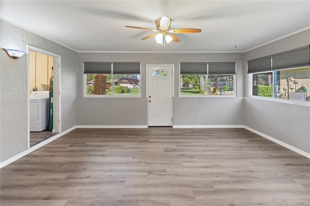 entryway featuring washer / dryer, ceiling fan, hardwood / wood-style floors, and a healthy amount of sunlight