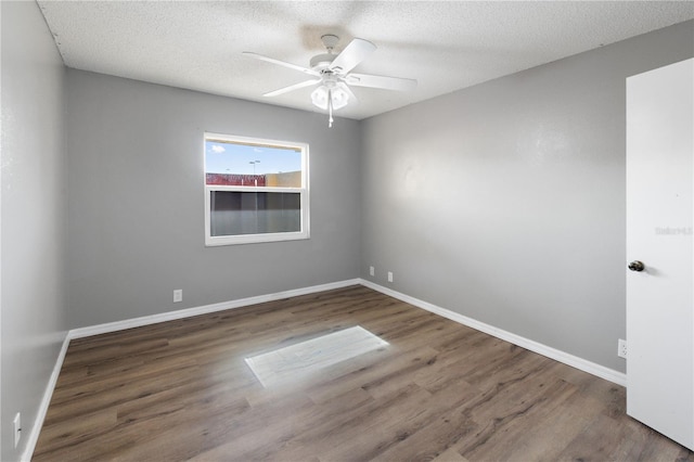 unfurnished room featuring ceiling fan, a textured ceiling, and dark hardwood / wood-style floors