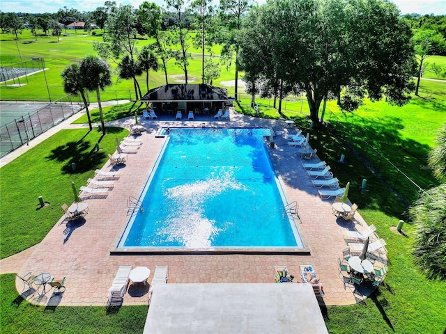 view of swimming pool with a lawn and a patio area