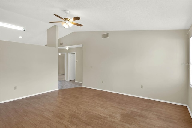 unfurnished room with lofted ceiling, ceiling fan, and dark hardwood / wood-style floors