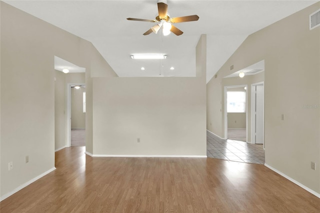 unfurnished room with light wood-type flooring, lofted ceiling, and ceiling fan