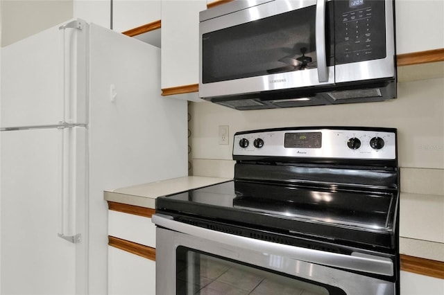 kitchen with stainless steel appliances and white cabinetry