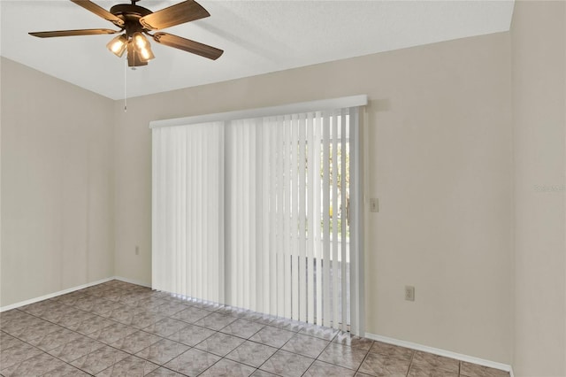 tiled spare room featuring ceiling fan