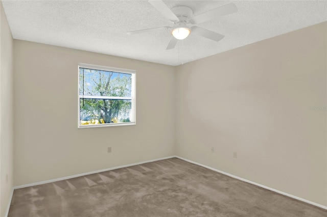 carpeted spare room featuring ceiling fan and a textured ceiling