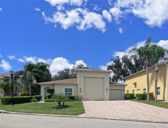 view of front facade with a garage and a front lawn