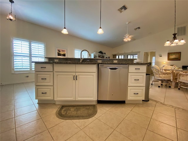 kitchen featuring lofted ceiling, dishwasher, light tile patterned flooring, white cabinetry, and decorative light fixtures