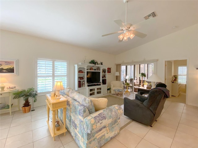 tiled living room featuring ceiling fan and high vaulted ceiling