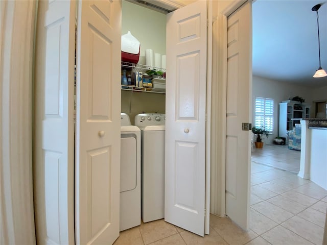 laundry room featuring light tile patterned floors and washer and clothes dryer