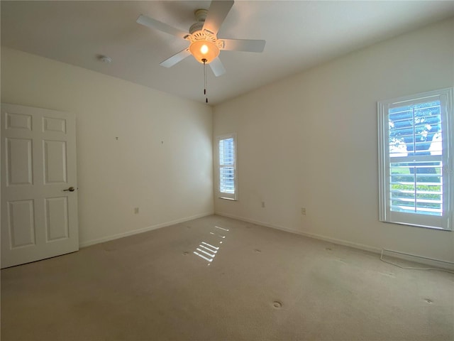 unfurnished room featuring ceiling fan and light carpet