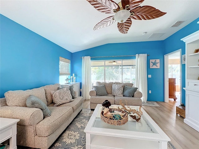 living room with light hardwood / wood-style floors, vaulted ceiling, and ceiling fan