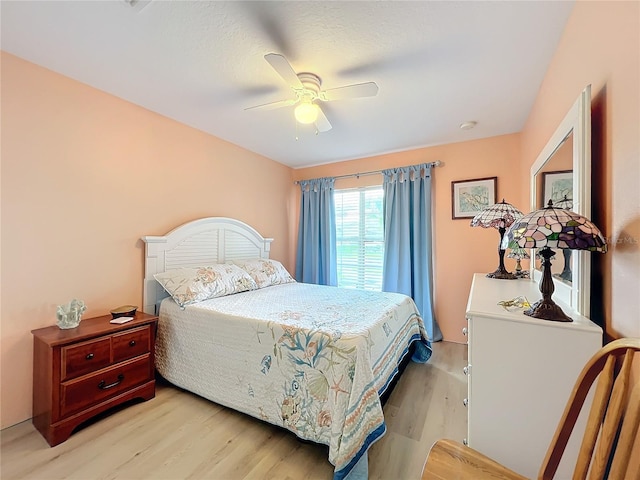 bedroom with ceiling fan and light hardwood / wood-style flooring