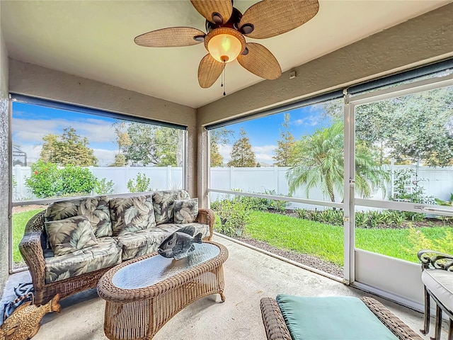 sunroom featuring ceiling fan and a wealth of natural light