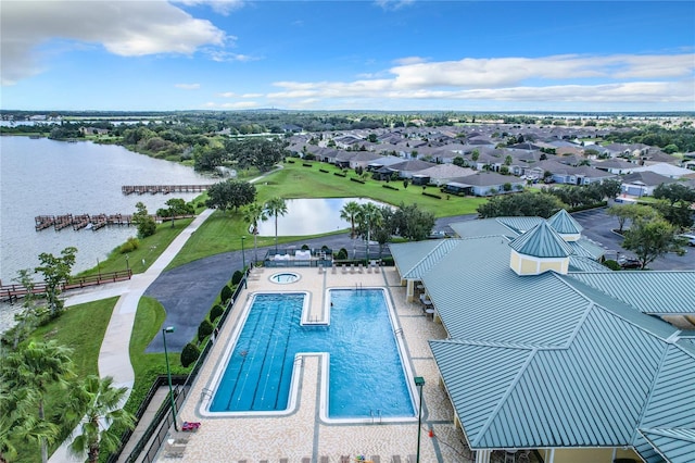 view of swimming pool featuring a water view and a patio area