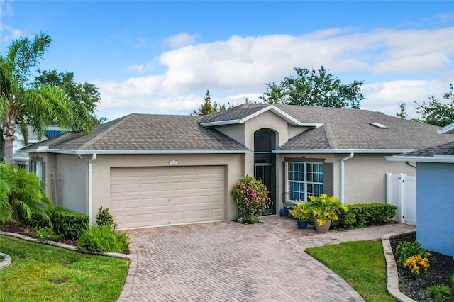 single story home with a front yard and a garage