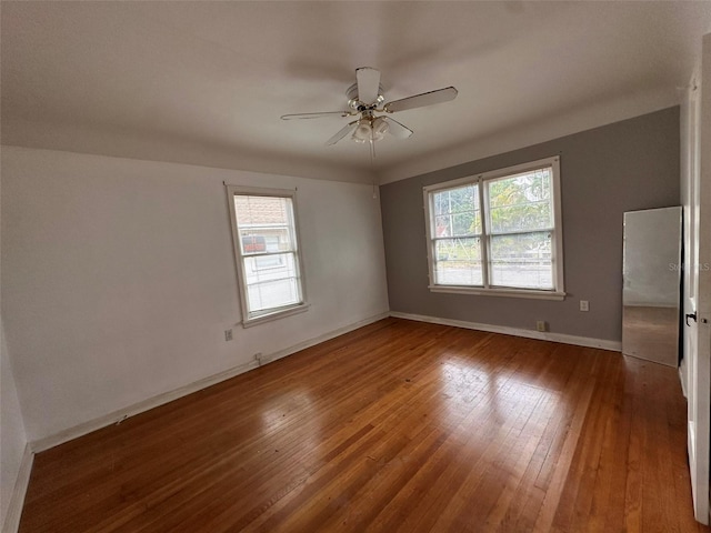 121 Bates Ave SE, Winter Haven, FL 33880 - unfurnished room with ceiling fan, hardwood / wood-style floors, and a healthy amount of sunlight
