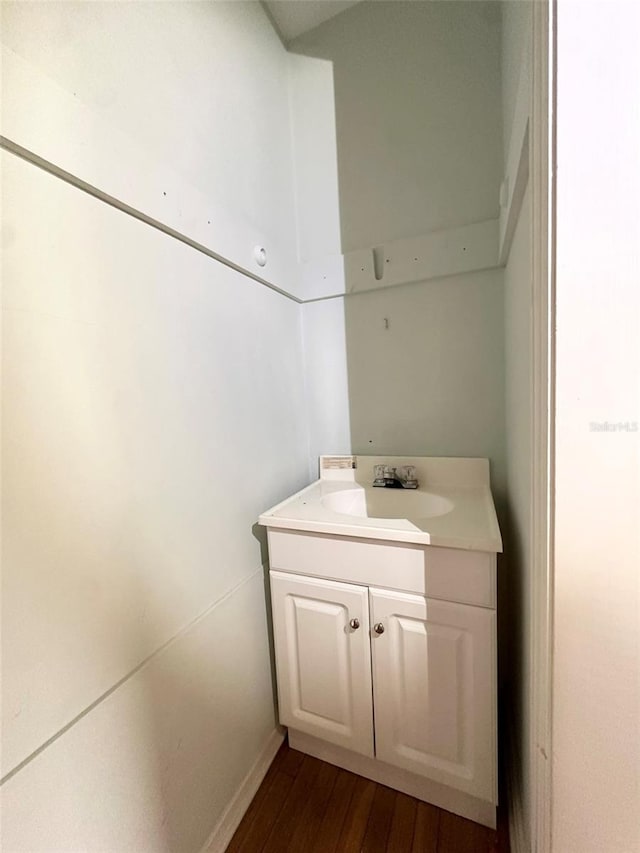 121 Bates Ave SE, Winter Haven, FL 33880 - bathroom featuring hardwood / wood-style flooring and vanity
