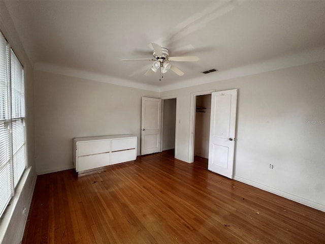 121 Bates Ave SE, Winter Haven, FL 33880 - unfurnished bedroom with dark hardwood / wood-style flooring and ceiling fan