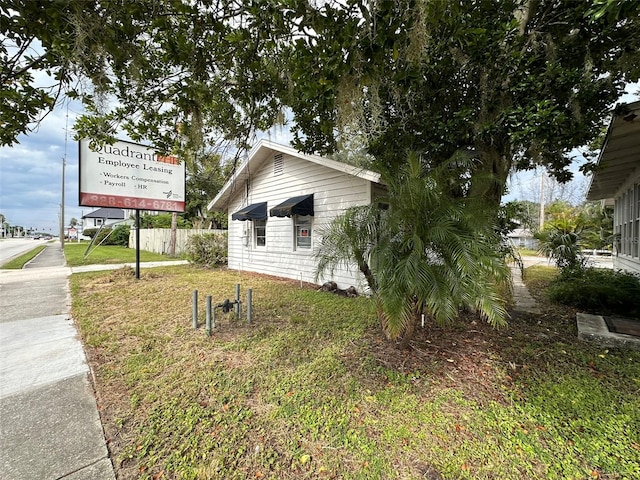 121 Bates Ave SE, Winter Haven, FL 33880 - view of home's exterior with a lawn