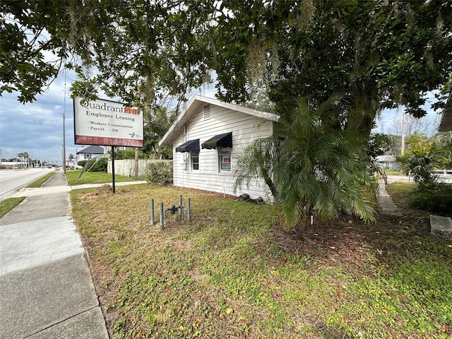 121 Bates Ave SE, Winter Haven, FL 33880 - view of home's exterior featuring a lawn